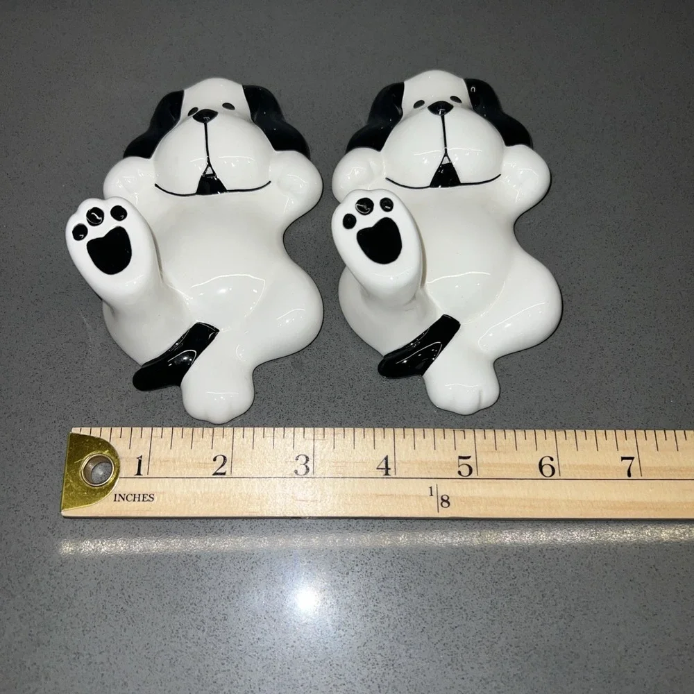Two black-and-white dog wall hooks
